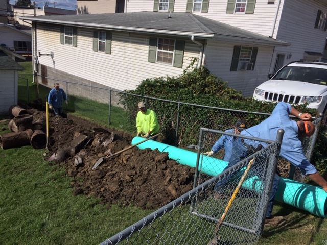 Workers Replacing an Underground Pipe