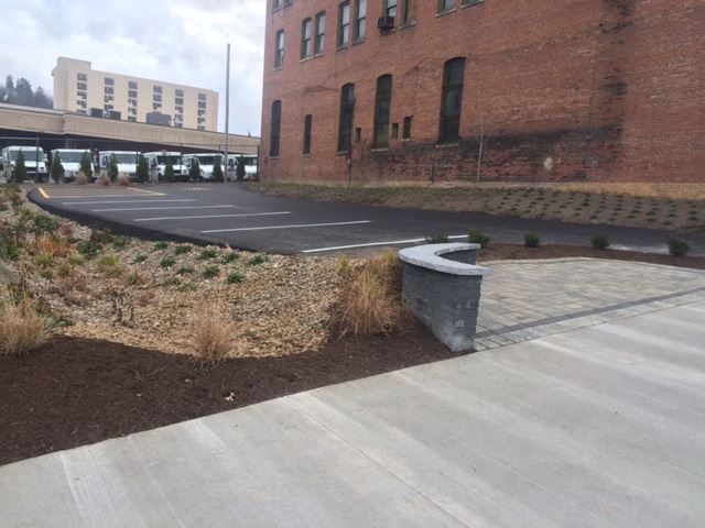 Newly Poured Parking Lot Surrounded by Water Runoff Features