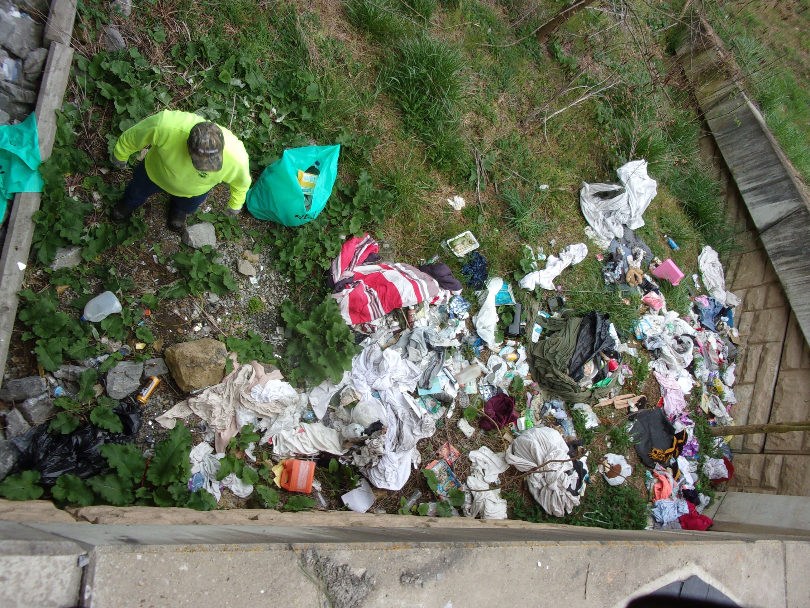 Litter and trash piled under the new bridge on Third Street.